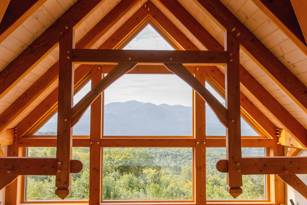 Exposed timber frame gable filled with full height glazing