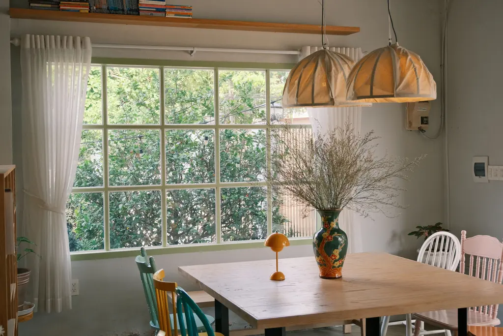 Dining space beside a large window with warm afternoon light