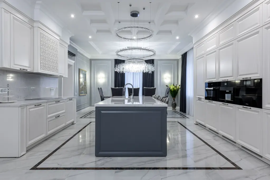 Contemporary kitchen with pale cabinetry and a full height island