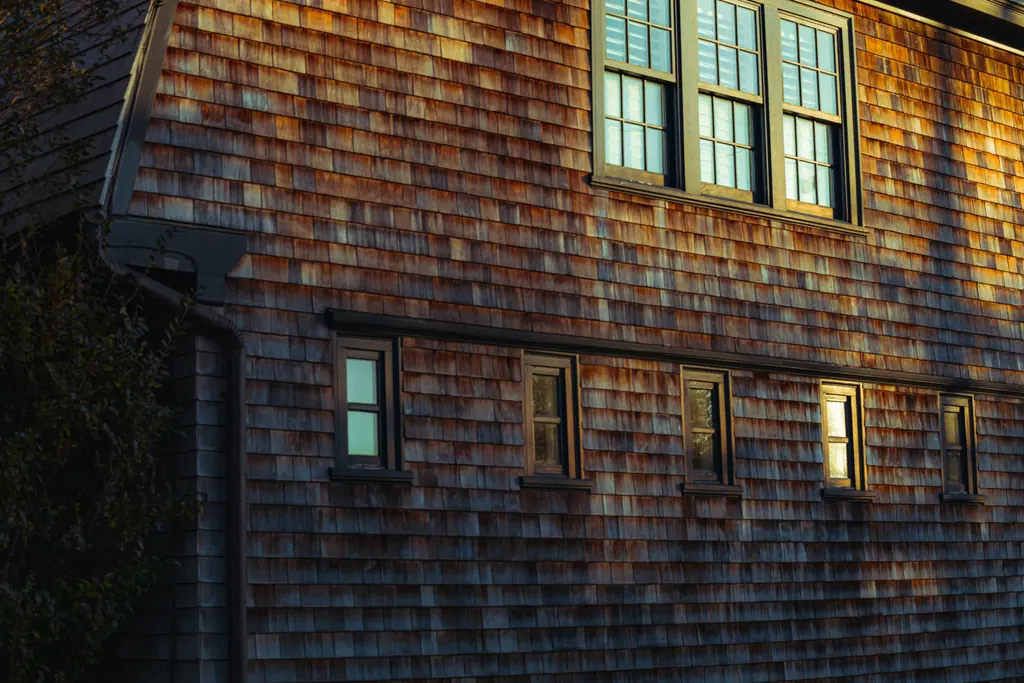 Cedar shingle house standing against a low coastal sky