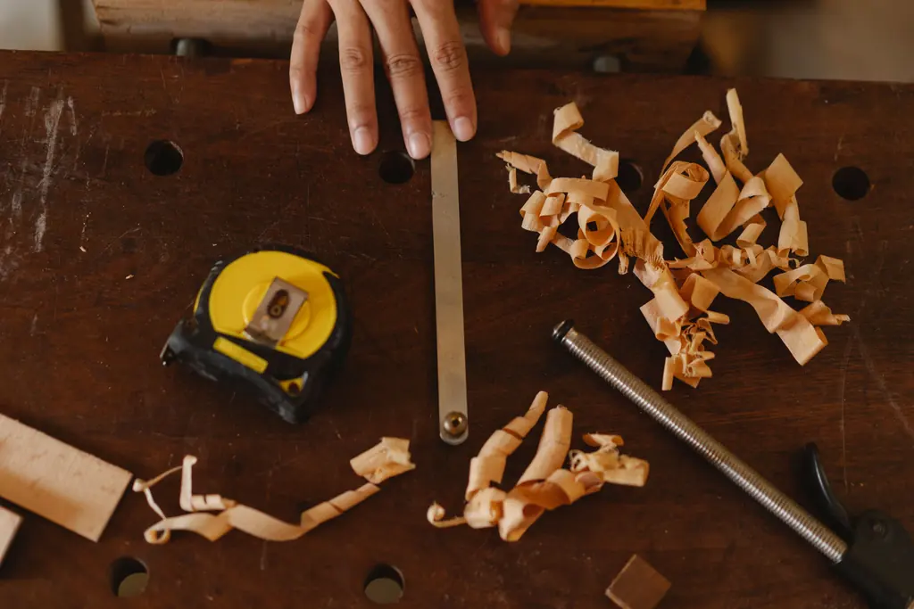 Hand tools and wood shavings scattered across a workbench