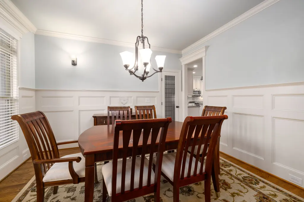 Dining room with panelled wainscot and a traditional table