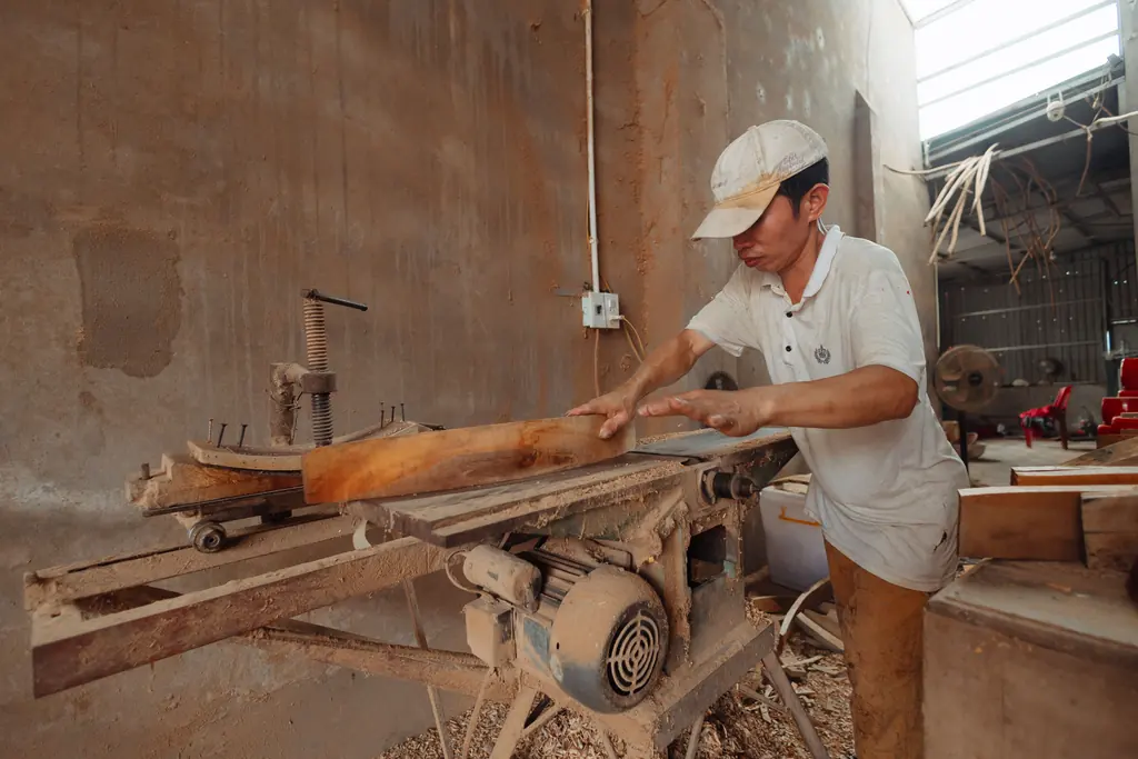 Carpenter working at a bench in a timber shop